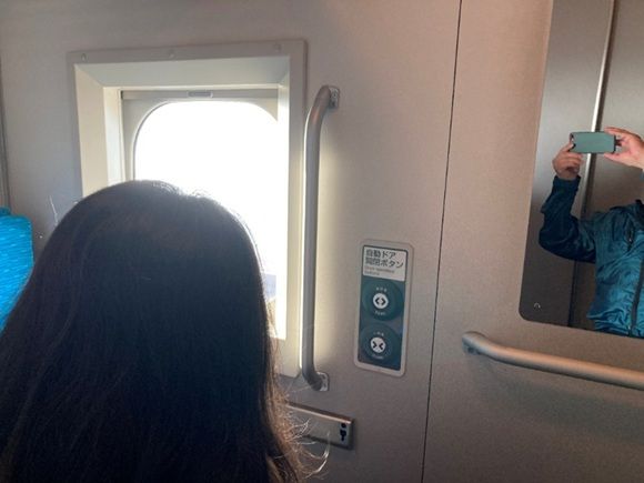 帰りの新幹線で、車窓の景色を眺めながら旅を振り返るMさん